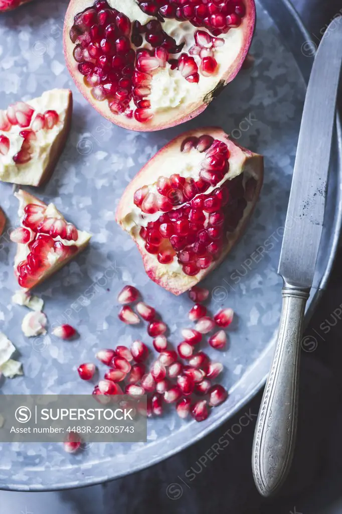 Pomegranate and seeds on a tray