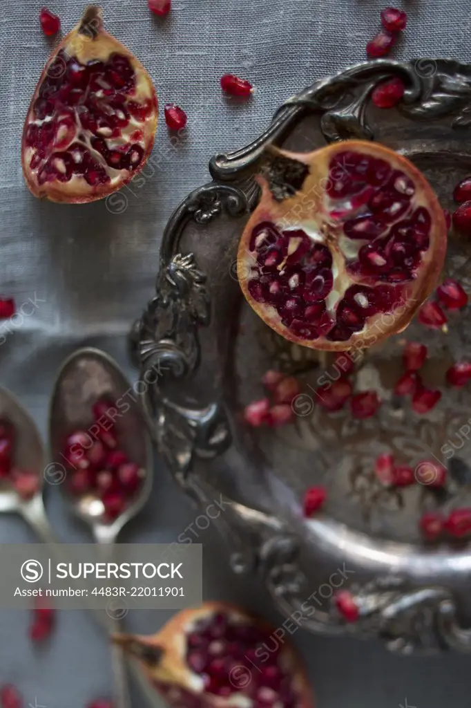 Pomegranate segments and seeds on a silver platter