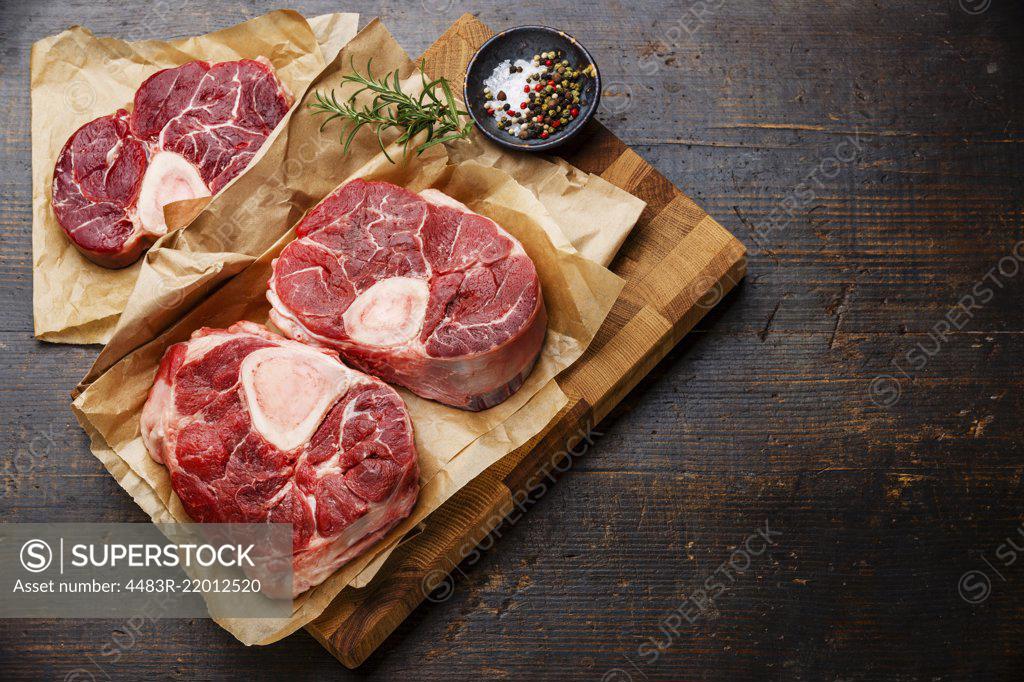 Raw fresh cross cut veal shank and seasonings for making Osso Buco on  wooden cutting board - SuperStock