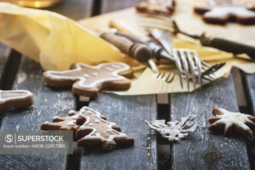 Christmas cookies on old wooden table with vintage cutlery