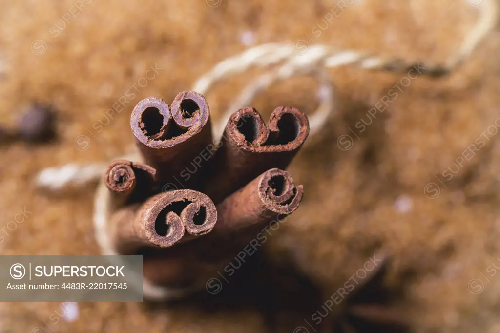 Spices cinnamon over heap of brown sugar. Top view. See series