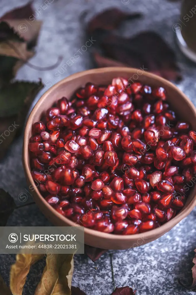 Pomegranate seeds in a ceramic bowl