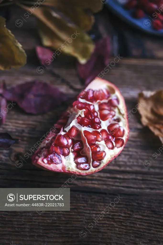 Piece of pomegranate on a rustic wooden table