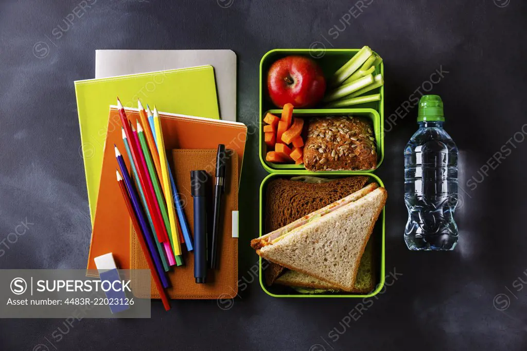 Take out food Lunch box with Sandwiches and vegetables, bottle of water and school supplies