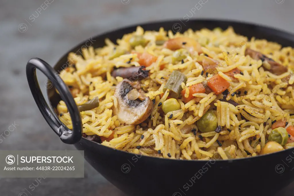 Indianrice dis vegetarian pulao in the black bowl. With copy space