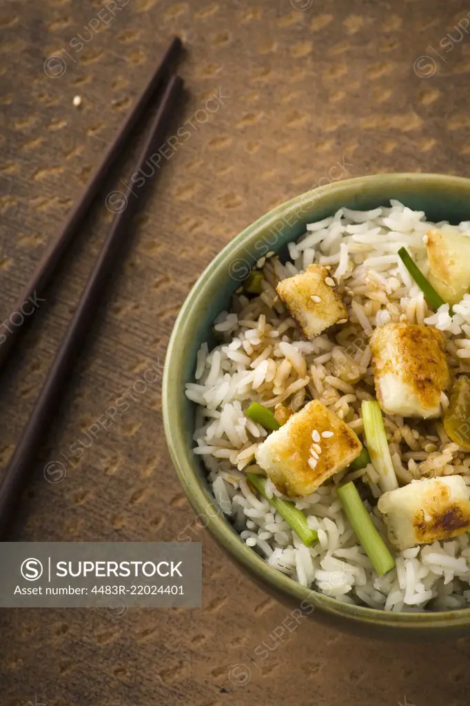 Bowl of lemon Rice with wild garlic and fried cheese