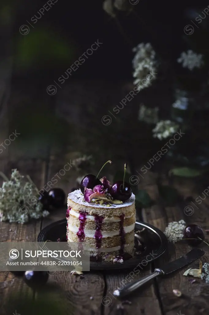 Black cherry cake on wooden table