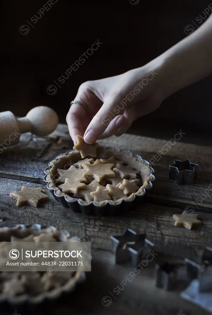 Woman's hands decorating a tart