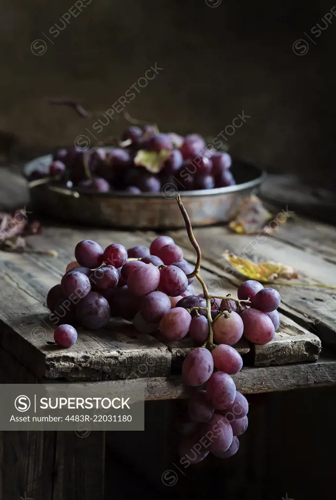 Fresh bunch of red grapes on wooden table