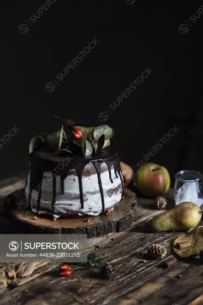 Autumn mood: chocolate & pear cake on wooden table