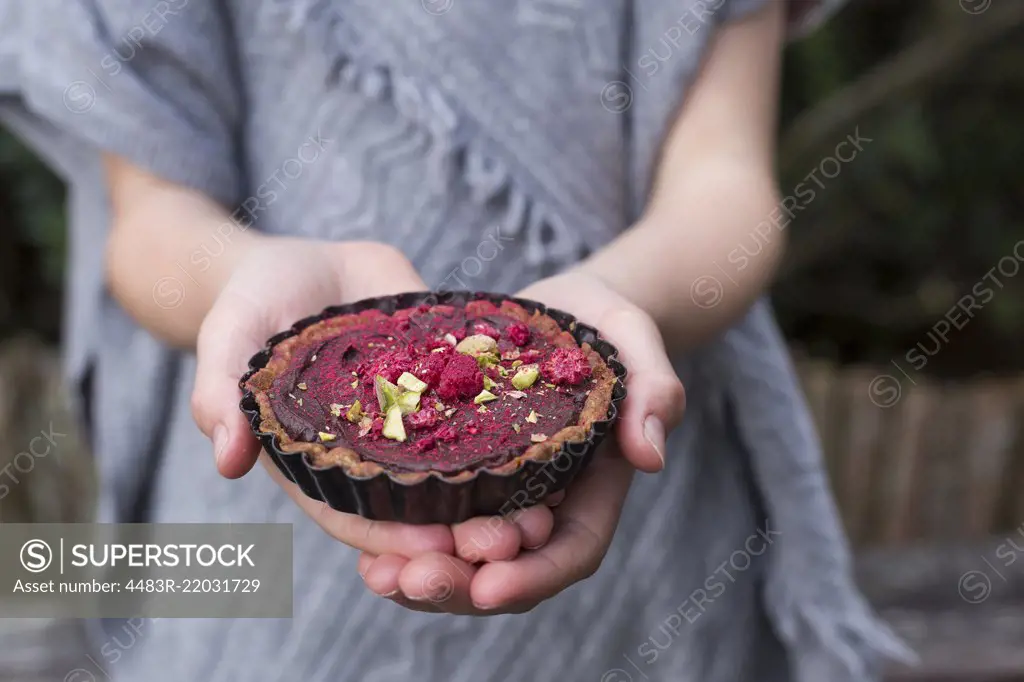 Spiced Chocolate Tarts being held in a girls hands