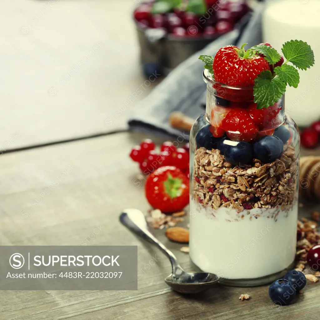 Yogurt with baked granola and berries - Healthy Breakfast concept