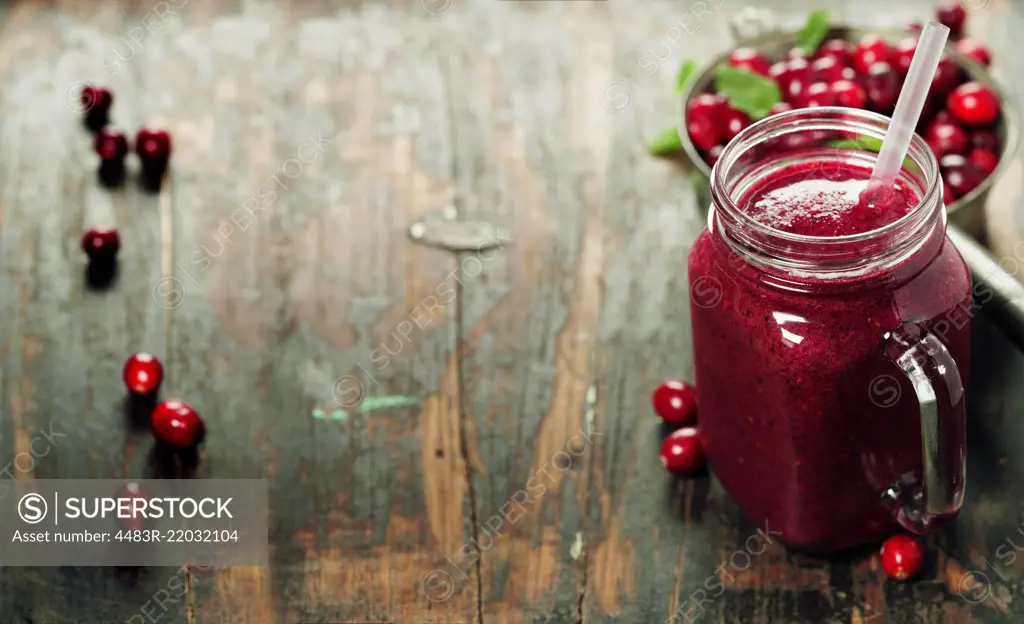 Cranberry smoothie on rustic wooden background - Healthy eating, Detox or Diet concept