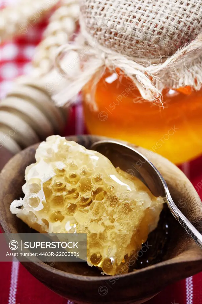 Beautiful honey comb, spoon and honey in jar