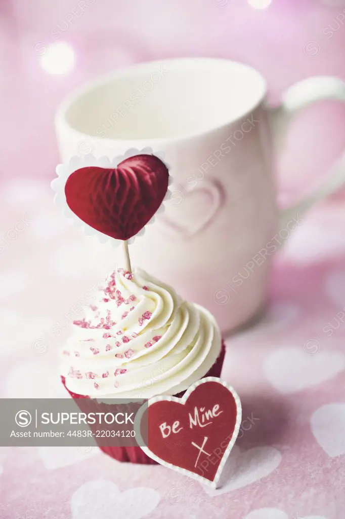 Cupcake decorated with a heart shaped cake pick