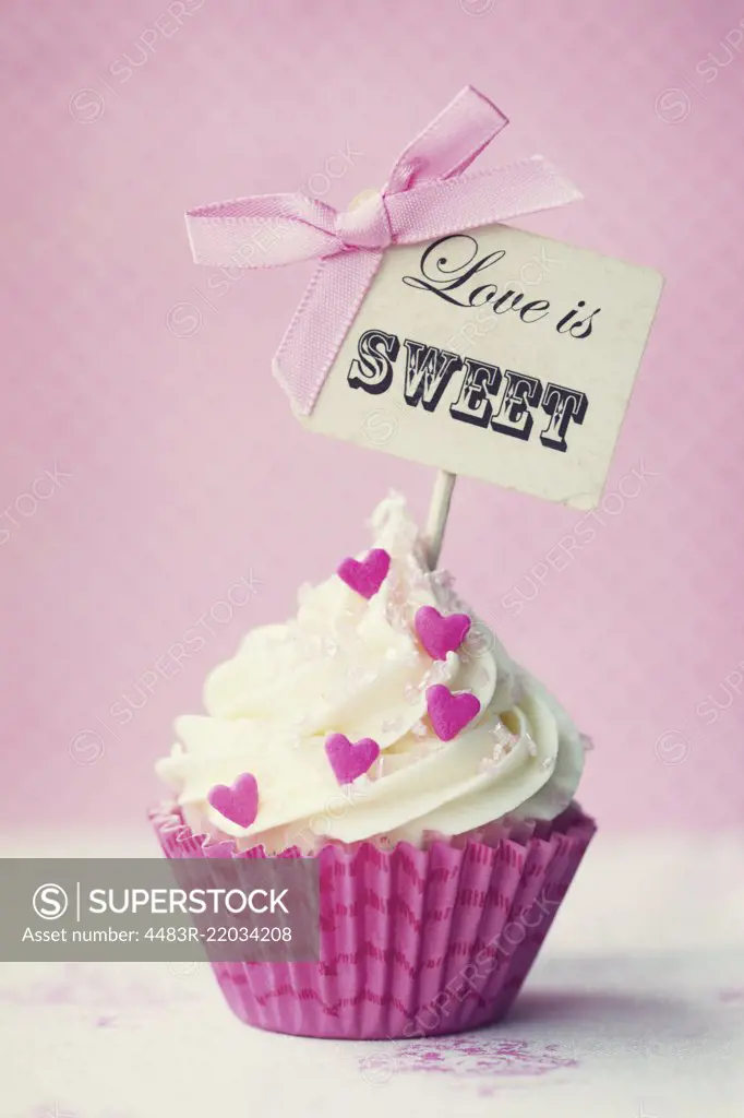 Cupcake with "love is sweet" pick