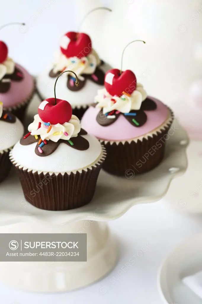 Cherry cupcakes on a cake stand