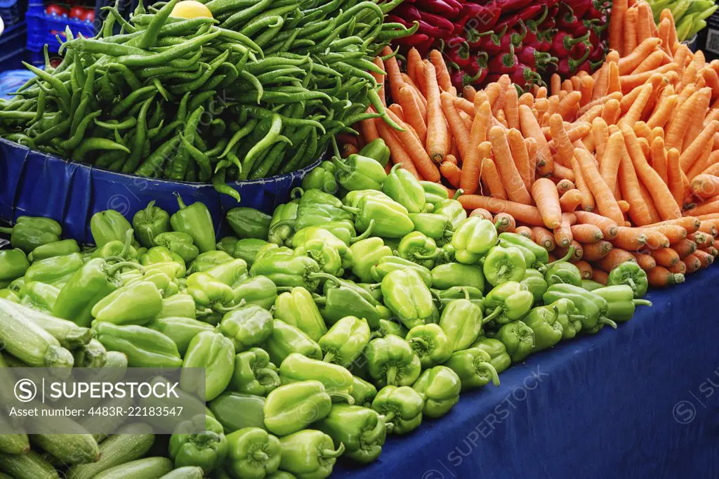 Turkish farmer market. Heap of fresh organic vegetables on the counter green paprika, peppers, red hot chili peppers, carrots