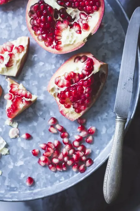 Pomegranate and seeds on a tray