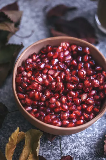 Pomegranate seeds in a ceramic bowl