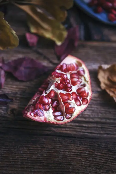 Piece of pomegranate on a rustic wooden table