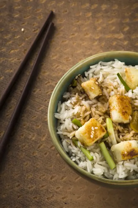 Bowl of lemon Rice with wild garlic and fried cheese