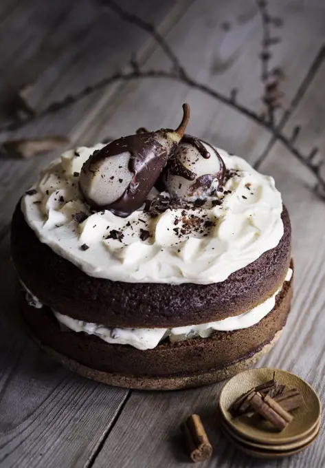 Chocolate cake with pears on wooden table