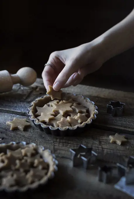 Woman's hands decorating a tart