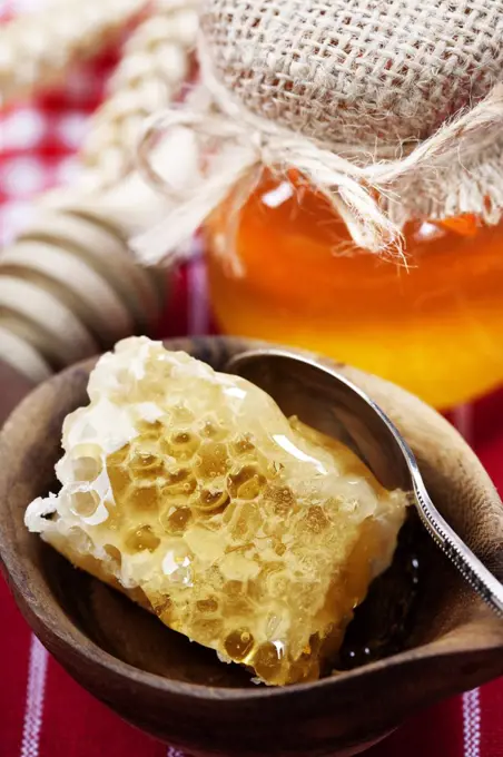 Beautiful honey comb, spoon and honey in jar