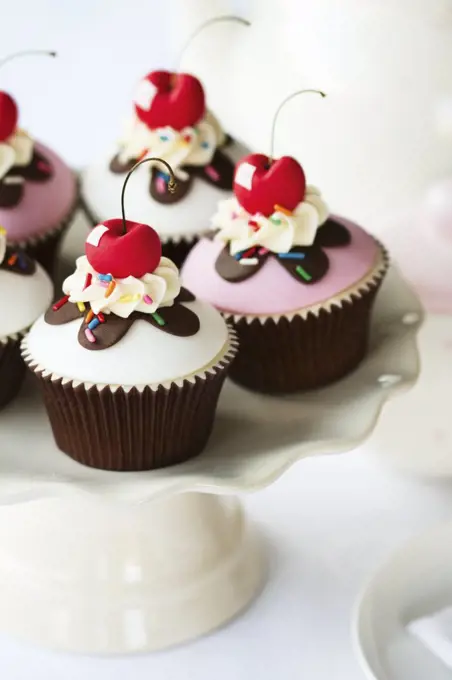 Cherry cupcakes on a cake stand