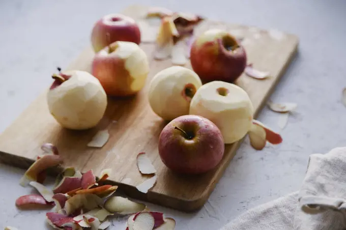 Peeling red apples for cooking an apple pie