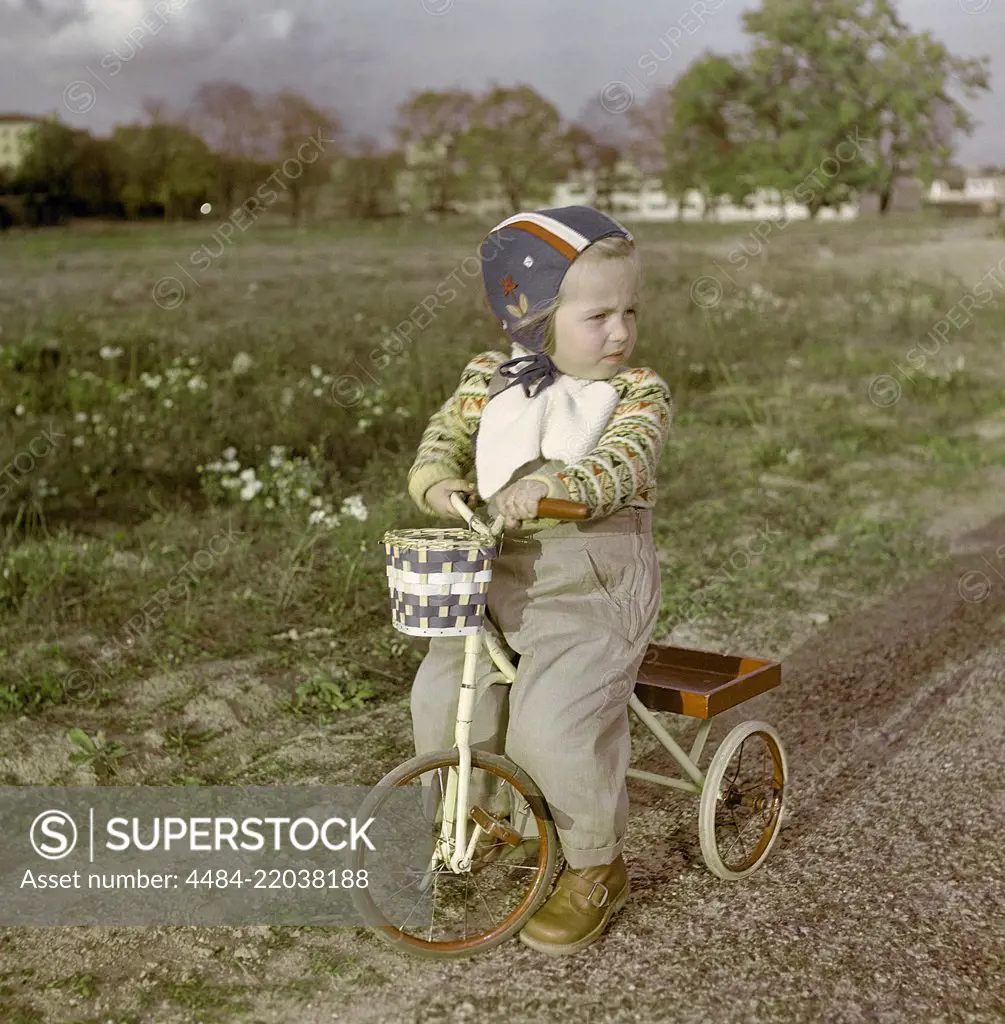 1950s girl on tricycle. A little girl is sitting on her tricycle. Sweden 1950s. ref CV21-4