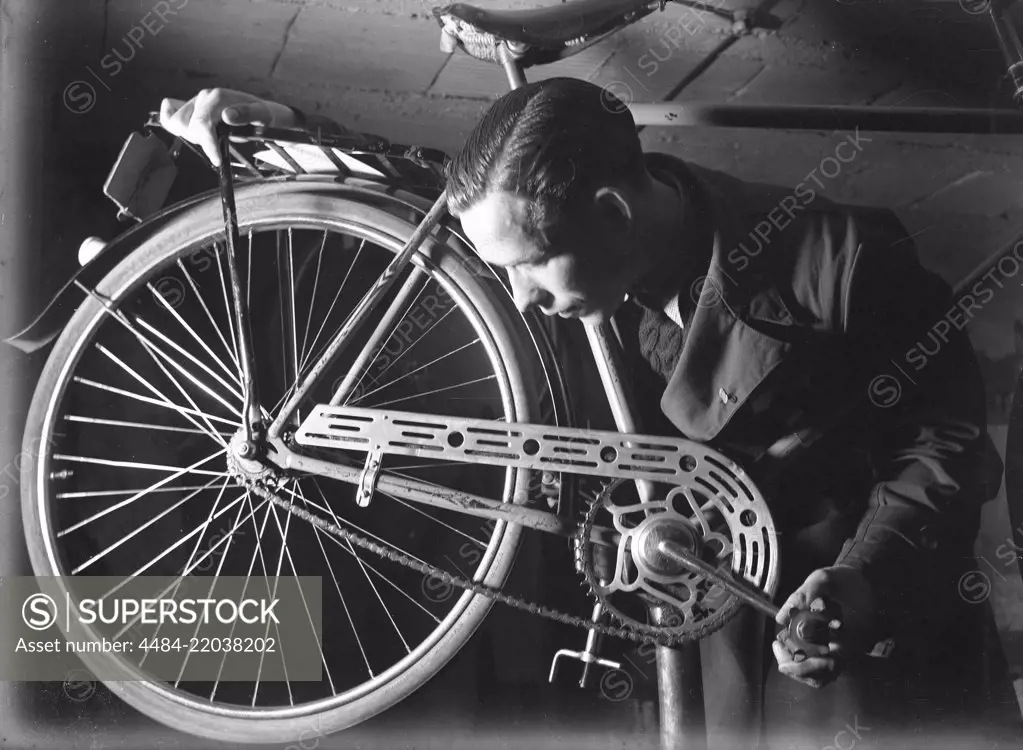 1940s man with bicycle. The Swedish athlete and olympic cyclist champion Ingvar Eriksson in his own bicycle shop where he sells and repairs bicycles. World War II has made petrol and oil expensive and rationed. Bicycles quickly became the most common means of transportation. 2 June 1940. Photo Kristoffersson 150-8