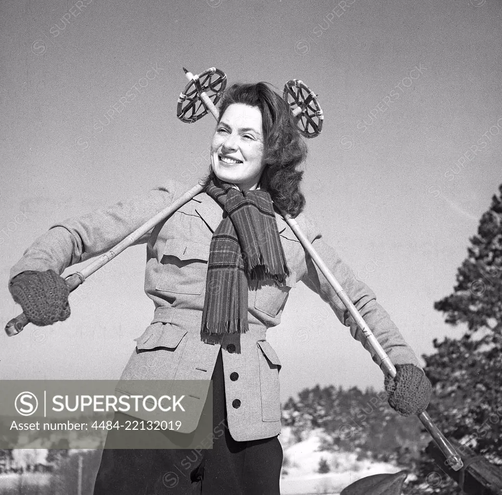 Winter in the 1940s. Actress Viveca Lindfors, 1920-1995. Pictured here ready to go cross country skiing. She is posing with the ski poles graphically behind her back. Sweden 1948. Photo Kristoffersson ref AA16-2