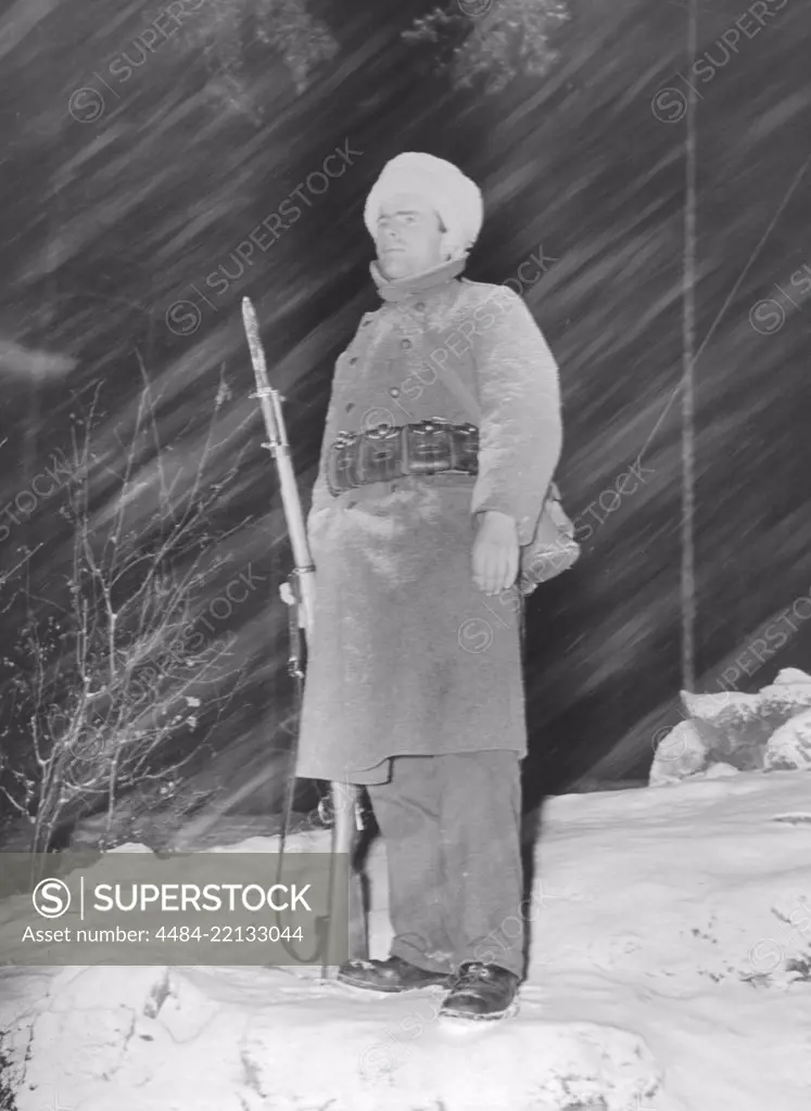 Swedish army during WW2. A soldier is standing in the snowfall och christmas eve 24 December. Sweden 1940s