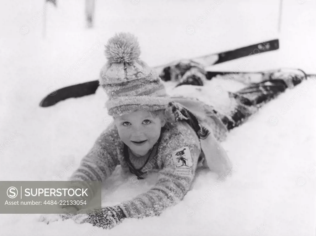 Winter in the 1950s. A girl in the skiing school is lying in the snow. Sweden 1950s