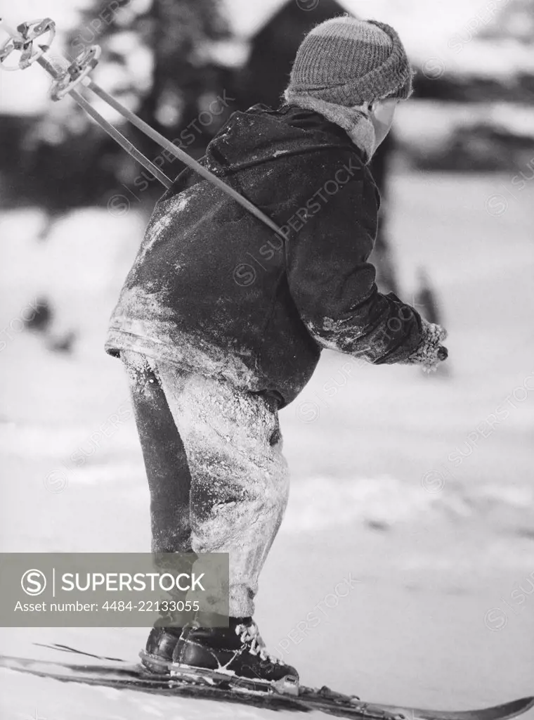 Winter in the 1960s. A boy is skiing. By the looks of the snow on his clothes, he has fallen many times. Sweden 1960s