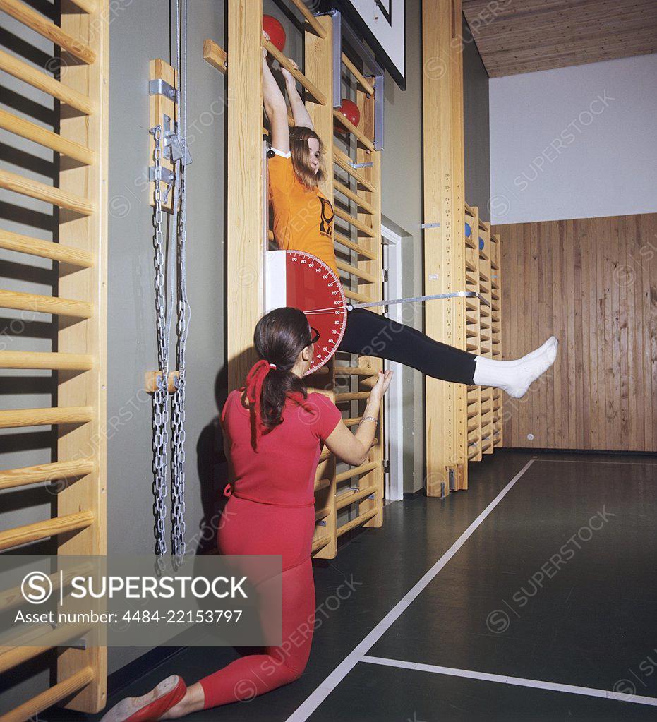 School Gymnastics In The 1970s A Teacher Is Helping A Young Girl