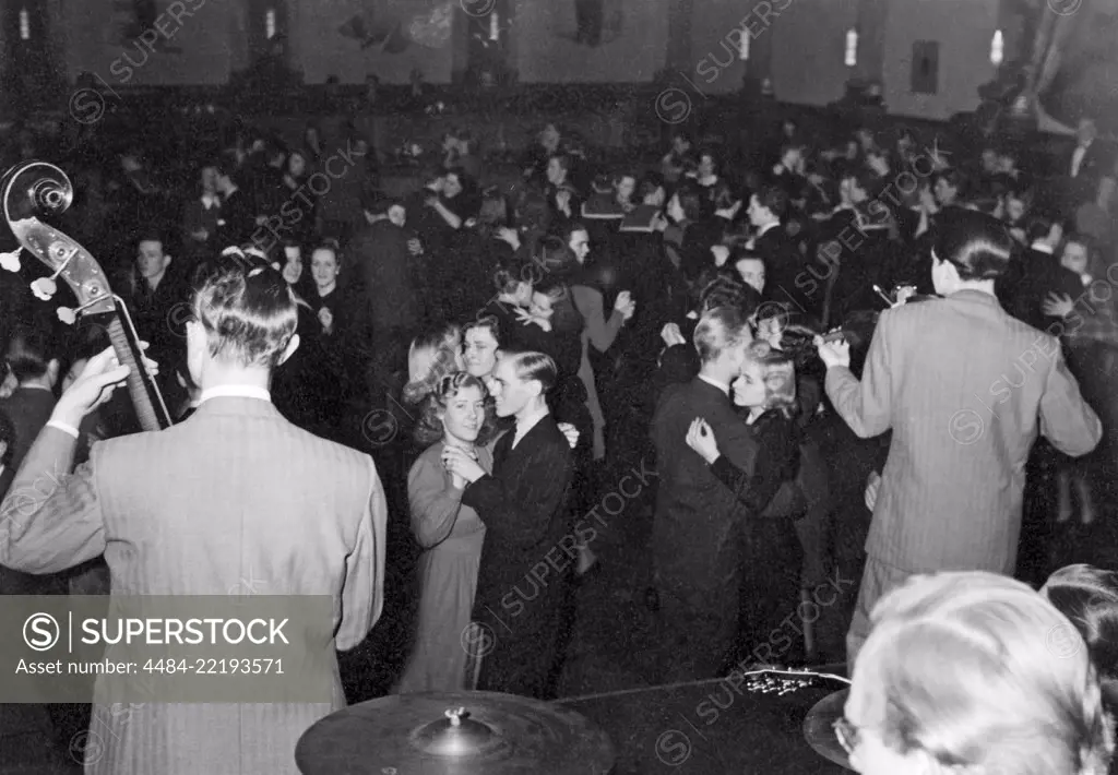 Dancing in the 1940s. The dance floor is filled with dancing couples moving to the band and he music. Picture taken at Nalen in StockholmSweden in the 1940s. 