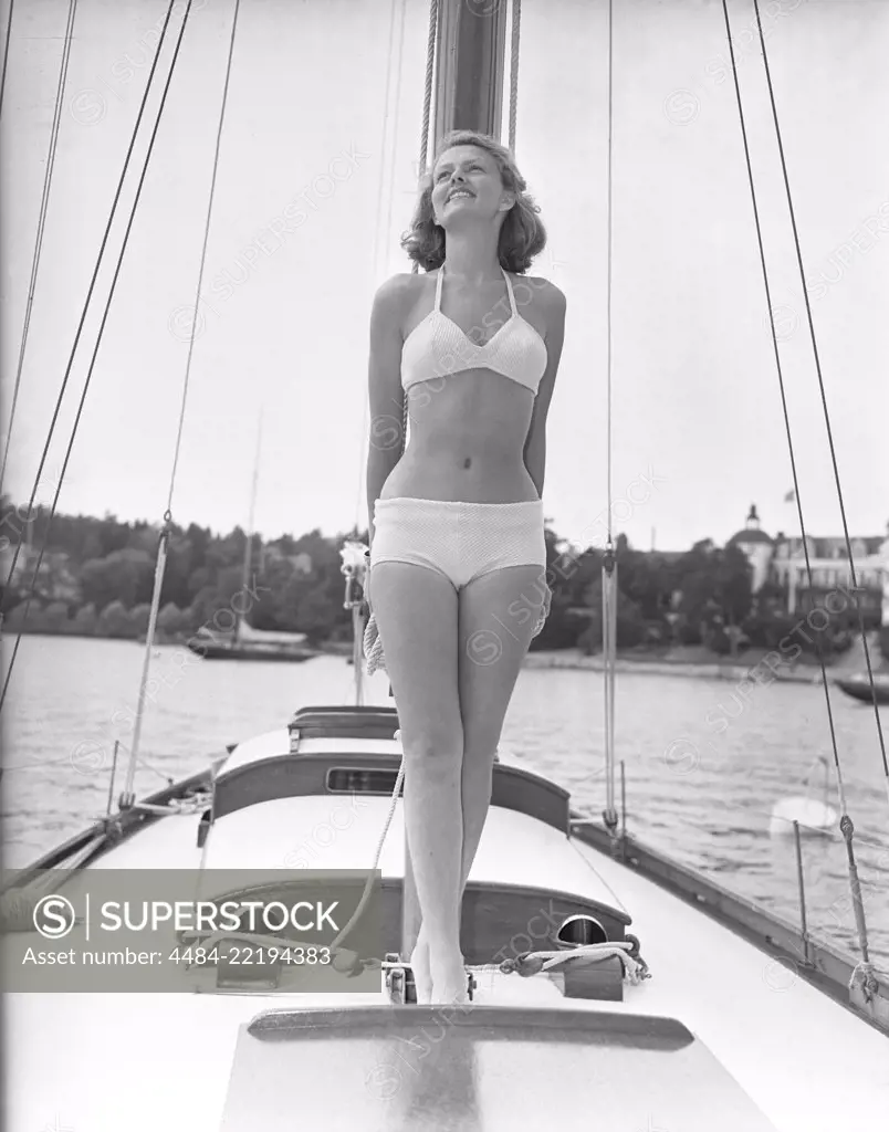 1940s bikinifashion. A swedish young woman in a white bikini on a sailing boat on a summer's day. Sweden 1948. Photo Kristoffersson ref 217a-2. Her name is Haide Göransson, swedish fashion model.