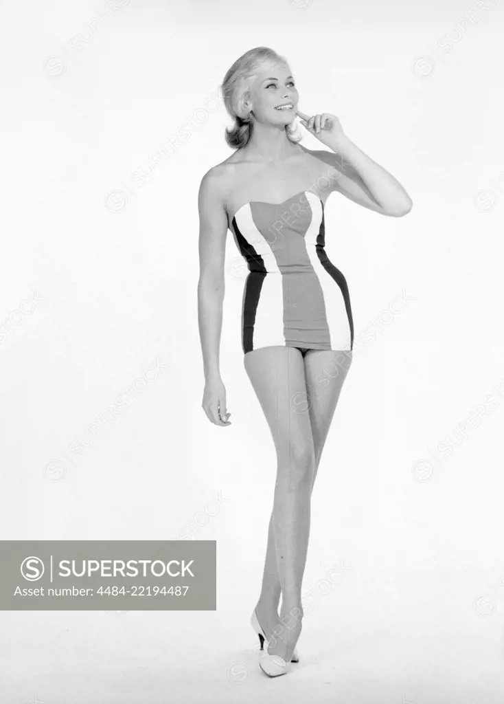 Blonde girl in black bikini - SuperStock