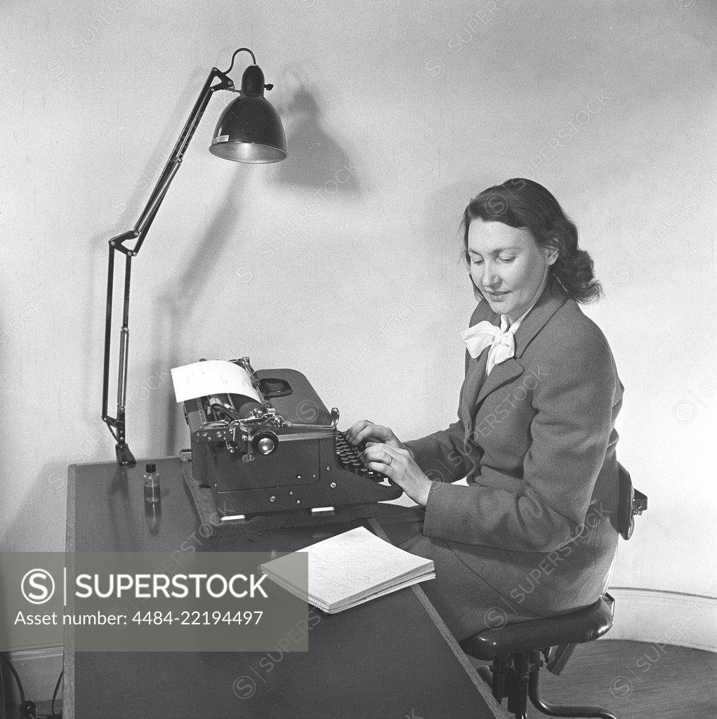 Office girl in the 1940s. A woman is sitting at a office desk