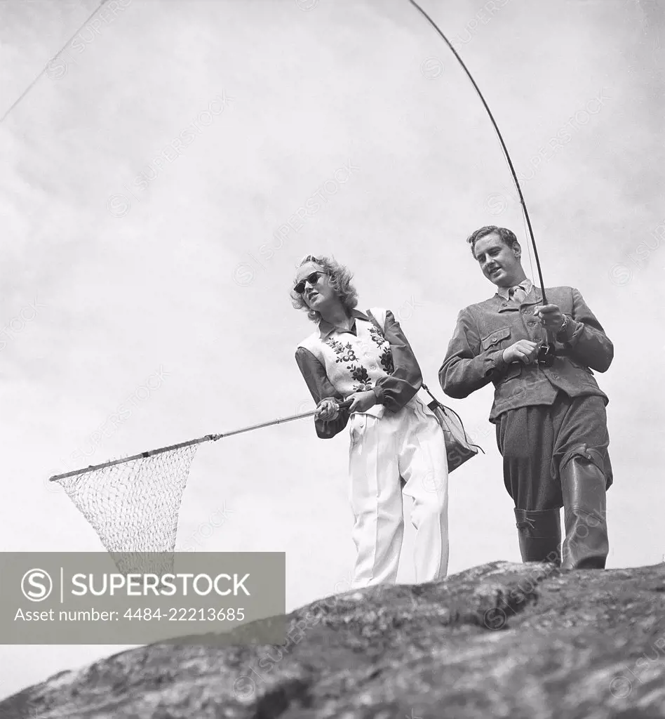 Fishing in the 1950s. A man with a fishing rod looks as if he has