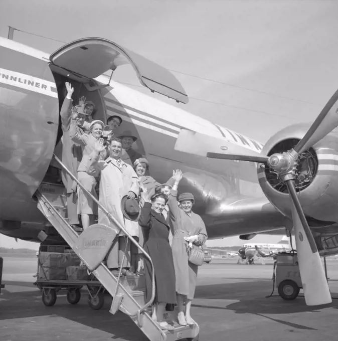 1950s vacation. A group of elderly people are standing on the stairs to an aircraft waving goodbye. Bromma airport Stockholm 1958. ref 3752