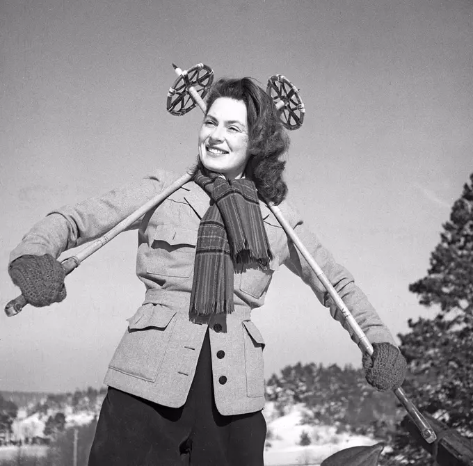 Winter in the 1940s. Actress Viveca Lindfors, 1920-1995. Pictured here ready to go cross country skiing. She is posing with the ski poles graphically behind her back. Sweden 1948. Photo Kristoffersson ref AA16-2