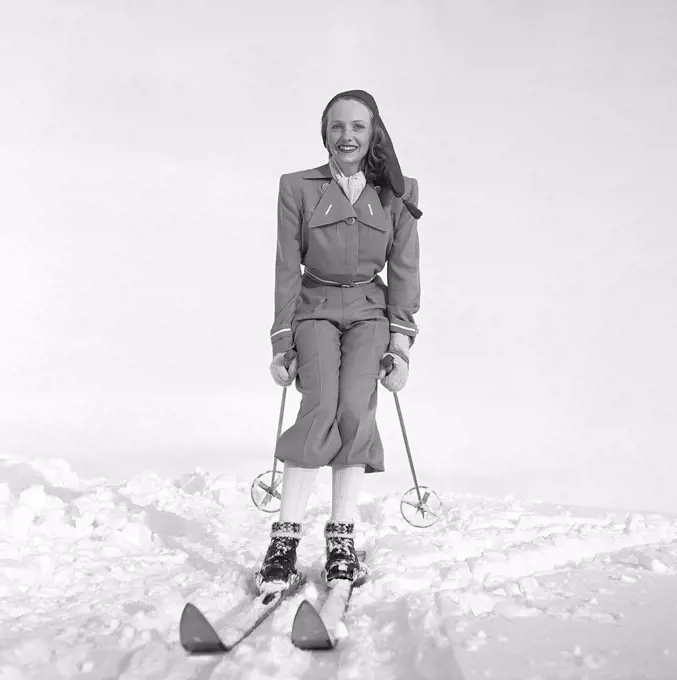 Winter in the 1940s. The young woman Vibeke Falk is dressed in the typical 1940s winter sports fashion. She is wearing matching jacket and trousers. Sweden 1944. Photo Kristoffersson ref F121-2