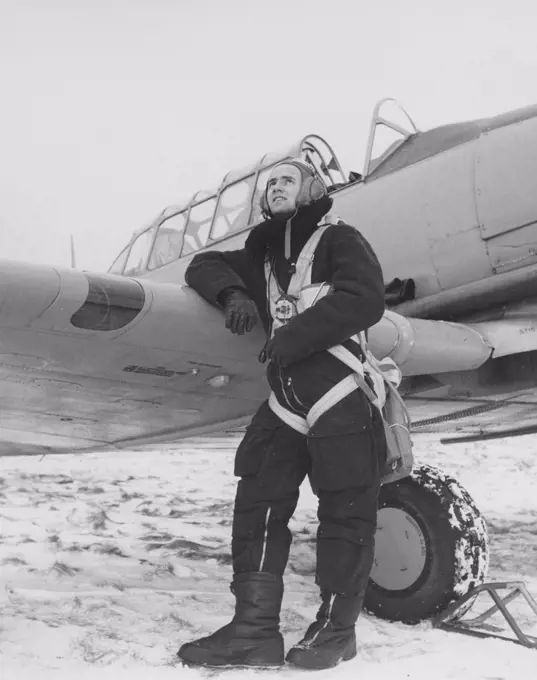 Pilot in the 1950s. A swedish pilot beside his aircraft a winter day. Sweden 1950s