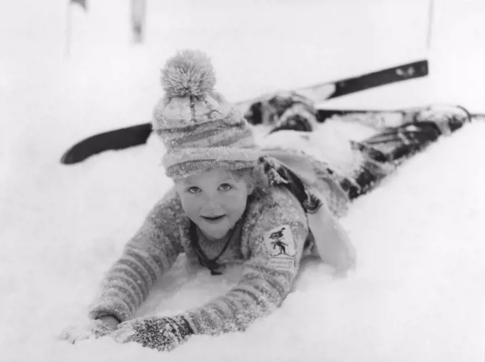 Winter in the 1950s. A girl in the skiing school is lying in the snow. Sweden 1950s