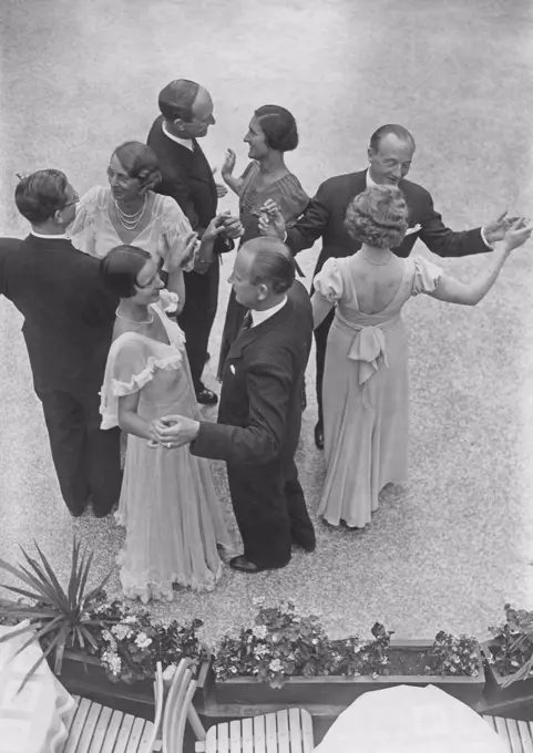 Dancing in the 1930s. Four couples at an outdoor garden party is dancing. 1930s