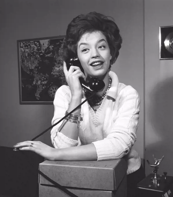 Woman in the 1950s. A young dark-haired woman speaking on the phone. She is the swedish singer Lill-Babs Svensson. 1938-2018. Ref 11-01-9